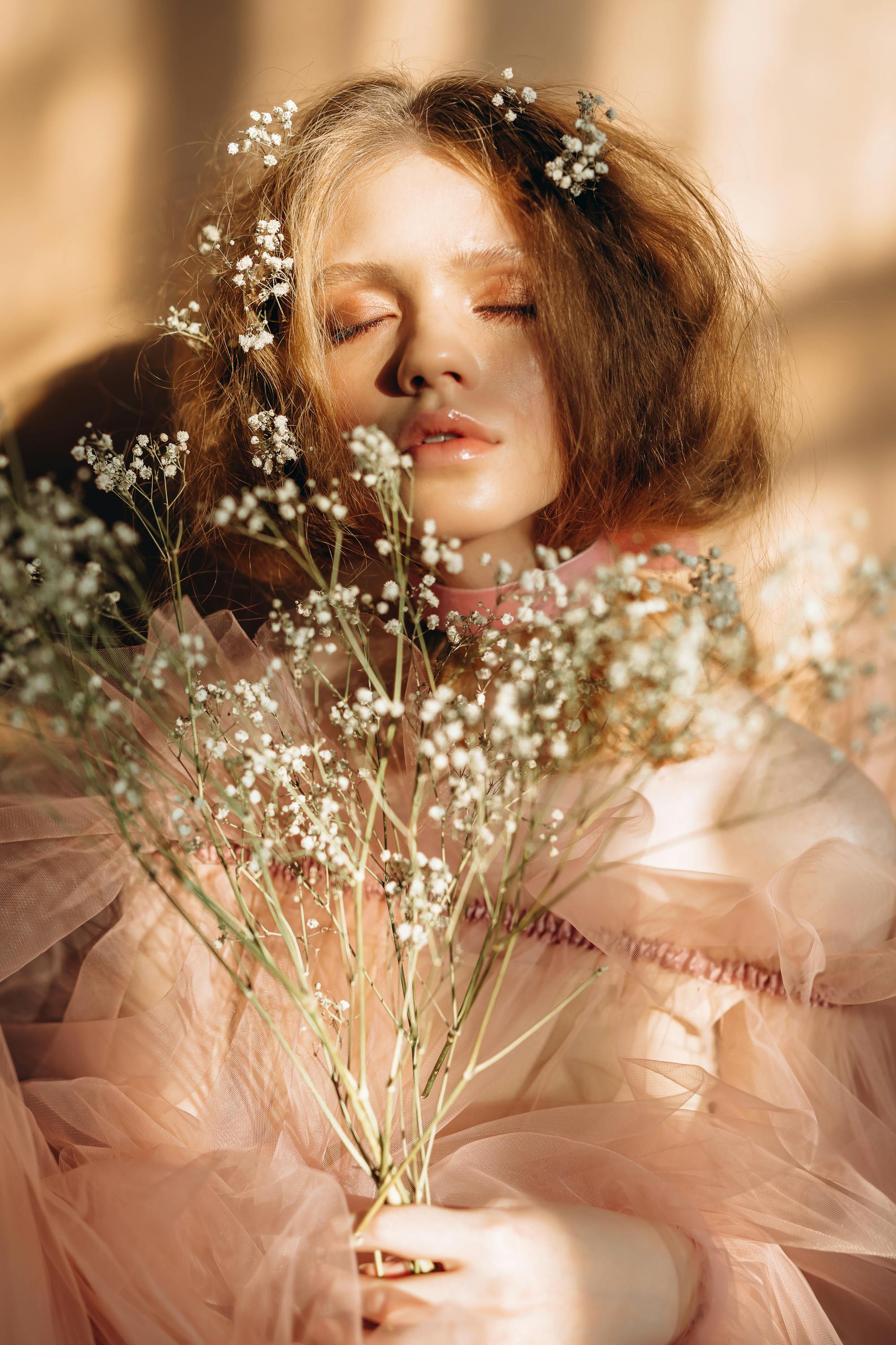 Portrait of a woman surrounded by delicate white flowers, representing beauty, confidence, and empowerment.